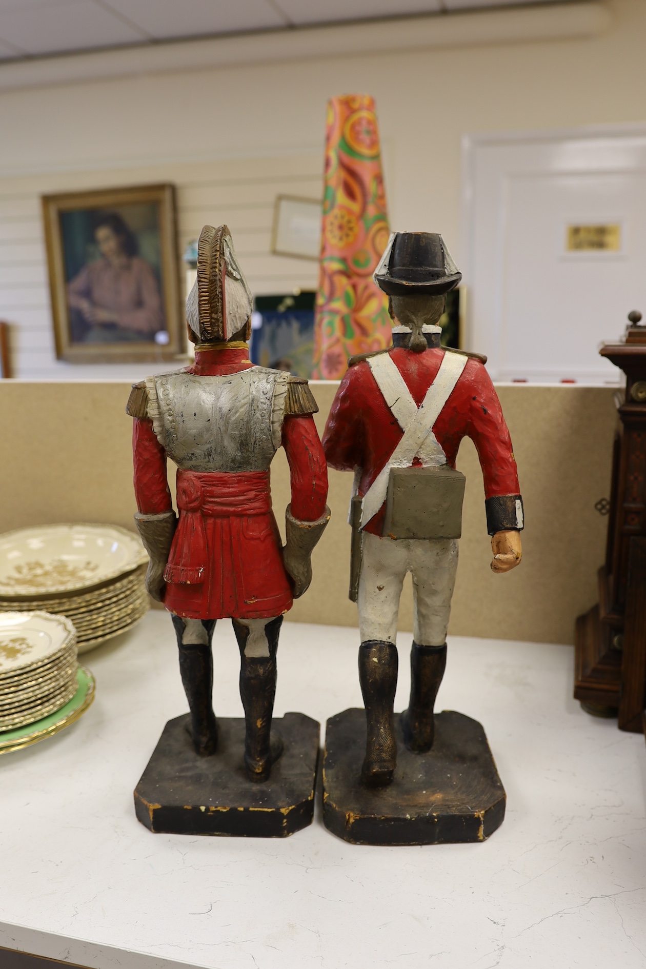 A pair of painted figures of soldiers in military dress, 49cm high. Condition - fair